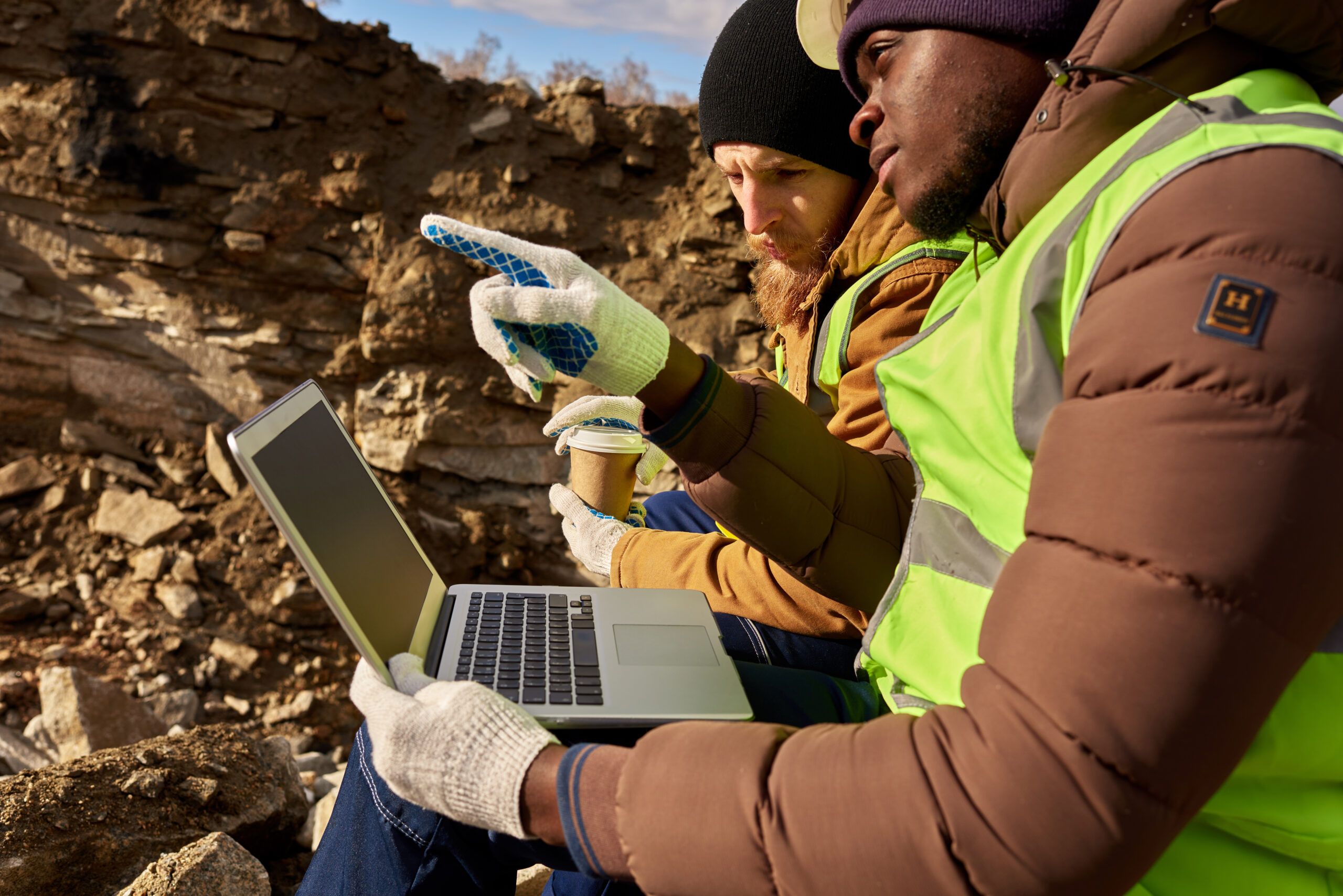 Mining  Workers Using Laptop on Excavation Site